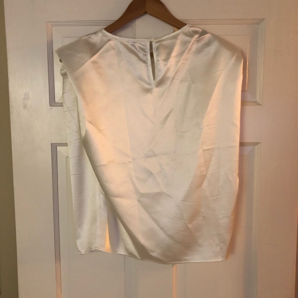 White satin sophisticated tank-like arm blouse.